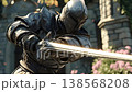 Epic medieval knight wearing full dark plate armor and a helmet, powerfully wielding a shiny two handed sword in front of a majestic ancient castle on a sunny day with particles flying around 138568208