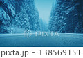 Snow Falls On Road Through Winter Forest 138569151