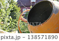 Throwing ingredients, gravel into an electric concrete mixer, for the preparation of mortar. 138571890