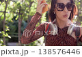 Happy young student dancing with smartphone in a public park 138576446