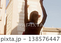 Happy young woman dancing in the city street 138576447