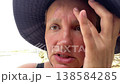 A woman treats a wound on her forehead while camping amateur portrait 138584285
