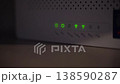 WiFi Router with Green LED Indicators Showing Active Connection 138590287