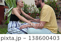 Romantic Couple Husband and Wife Holding Hands on Tropical Resort Patio Conversation 138600403