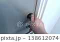 Woman locking door from inside, privacy and security concept. 138612074