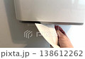 Woman hand pulling paper towel from dispenser, hygiene and cleanliness concept, 138612262