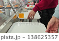 A person carrying a white tray with a fresh vegetable salad 138625357