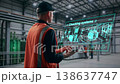 Technical Expert In Orange Safety Vest Assessing Digital Dashboards In Industrial Environment 138637747