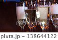 Pouring champagne into glasses for celebration at a gathering event 138644122