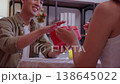 Romantic asian man giving heart shape gift box to girlfriend, surprise for Valentine's Day. 138645022