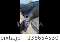 Snow melts on the roof, drops of water fall to the ground. Spring thaw. Spring mood. 138654530