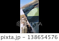 Snow melts on the roof, drops of water fall to the ground. Spring thaw. Spring mood. 138654576