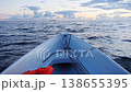 fishing boat on the open sea moves along the waves 138655395