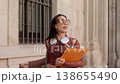 Joyful university student dancing on city street 138655490