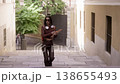 Happy young woman dancing on street steps 138655493