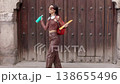 Happy young woman dancing while walking in the street. door, Background, 138655496