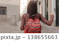 Happy young woman dancing while walking in a city street 138655663