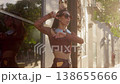 Happy stylish woman dancing in city street 138655666