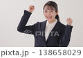 A young woman in a suit making a victory pose. A young woman in a suit making a victory pose. 138658029