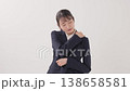 A young woman in a suit suffering from stiff shoulders A young woman in a suit suffering from stiff shoulders 138658581
