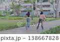 Teen Girl Falling on Grass While Rollerblading with Friend in Park 138667828