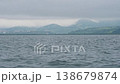 The city of Petropavlovsk-Kamchatsky and the waves of Avacha Bay in the Pacific Ocean in gloomy, cloudy, rainy weather. 138679874