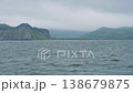Waves against the backdrop of the mountainous coast of Avacha Bay in the Pacific Ocean of the Kamchatka Peninsula in cloudy, overcast weather 138679875