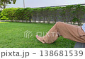 bare feet touching green grass in the park for earthing. High quality photography showing natural healthcare, grounding therapy, relaxation, wellness, and healthy outdoor lifestyle 138681539