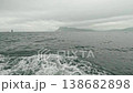 A view from a motorboat in the open Pacific Ocean during cloudy, choppy weather. Waves splash from below in all directions 138682898