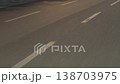 A broken line of white road markings. Close-up in motion. 138703975