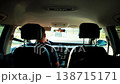View from inside car, passenger perspective looking forward, driver hands on steering wheel, road ahead, vehicle traffic, clear day, modern auto interior 138715171