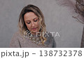 woman pill, tablet glass, healthcare woman. Smiling woman in cozy sweater drinks from glass of water after taking pill in modern indoor environment. 138732378