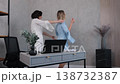 female friends, office greeting, career woman. Friend visits woman working on her laptop, and they are delighted to see one another. 138732387
