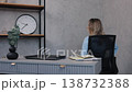 happy woman, office workplace, success celebration. Joyful woman in office attire raises her arm in celebration, smiling with happiness at her desk after successful work achievement. 138732388