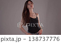 Body Positivity and Self-Acceptance Concept Young Woman Posing Confidently in studio with Neutral 138737776