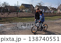 Supportive sister teaching younger brother to ride a bicycle 138740551