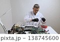 Technician repairing computer motherboard using multimeter 138745600
