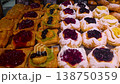 Assorted sweet pastries with fruit topping on bakery display 138750359