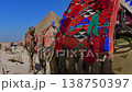 Decorated camels in front of Pyramid of Khafre at Giza plateau, Egypt. Colorful camel caravan with locals in sandy desert under vivid blue sky. Travel content. 138750397