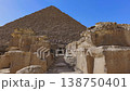 Pyramid of Menkaure with mortuary temple entrance and massive granite blocks in foreground at Giza, Egypt. Ancient archaeological site under blue sky. Travel and history. 138750401