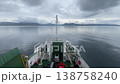 Car ferry navigating calm sea under cloudy sky 138758240