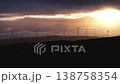 Silhouetted wind turbines generating renewable energy at sunset 138758354