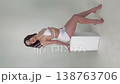 Elegant Woman in White Posing Gracefully in Studio 138763706