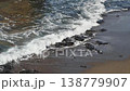 White waves lapping against the shore 138779907