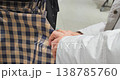 Woman's Hands Checking Fabric Quality at Store 138785760