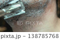Personal hygiene routine: shaving a man's face with a vintage-style razor. 138785768