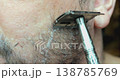 Personal hygiene routine: shaving a man's face with a vintage-style razor. 138785769