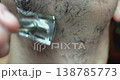 Personal hygiene routine: shaving a man's face with a vintage-style razor. 138785773