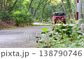 A car speeding away on a winding forest road near Lake Shikotsu. 138790746