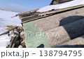 Snow melts on the roof, drops of water fall to the ground. Spring thaw. Spring mood. 138794795